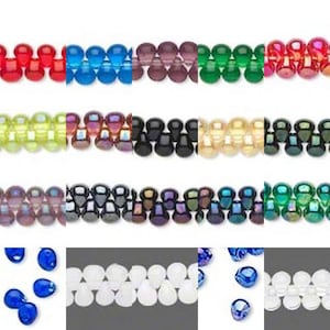 May include: Rows of colorful beads in various shades, including red, blue, purple, green, and yellow. The beads are teardrop-shaped and arranged in a grid pattern. Some beads are opaque, while others are translucent.