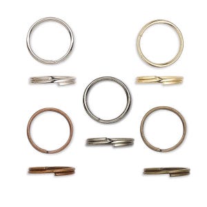 May include: A collection of metal key rings in various colors, including silver, gold, bronze, and copper. The key rings are shown both open and closed, with a split ring design for easy attachment. The rings are circular and vary in finish.
