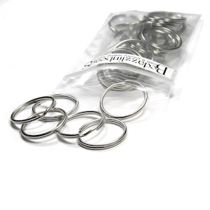 May include: A bag of silver key rings. The bag is labeled "BeadzUnlimited" and says "code & jewelry findings".