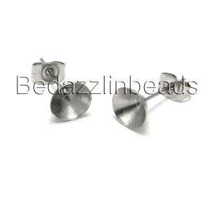 May include: Two silver earring posts with a round, cup-shaped top. The posts are made of stainless steel.