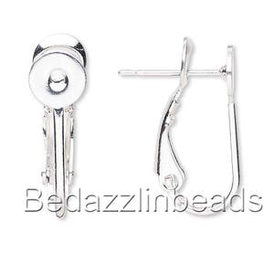 May include: Silver tone earring findings with a clip-on back. The findings are designed to hold a bead or other embellishment.