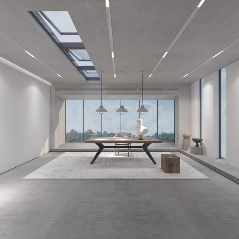 May include: A modern interior space with a large wooden table, a rug, and a bust sculpture. The room has large windows, pendant lights, and a skylight. The color palette is neutral, with shades of gray and brown.
