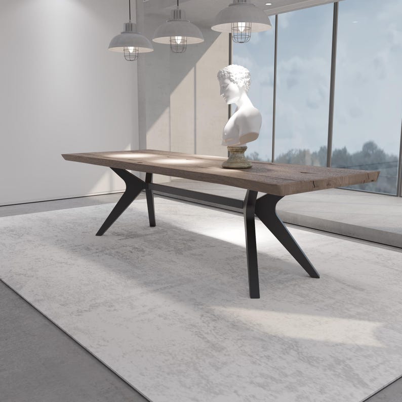 May include: A large, rectangular wooden table with a dark finish and black metal legs. The table is in a modern room with a white bust sculpture on top. The table is approximately 96 inches long.