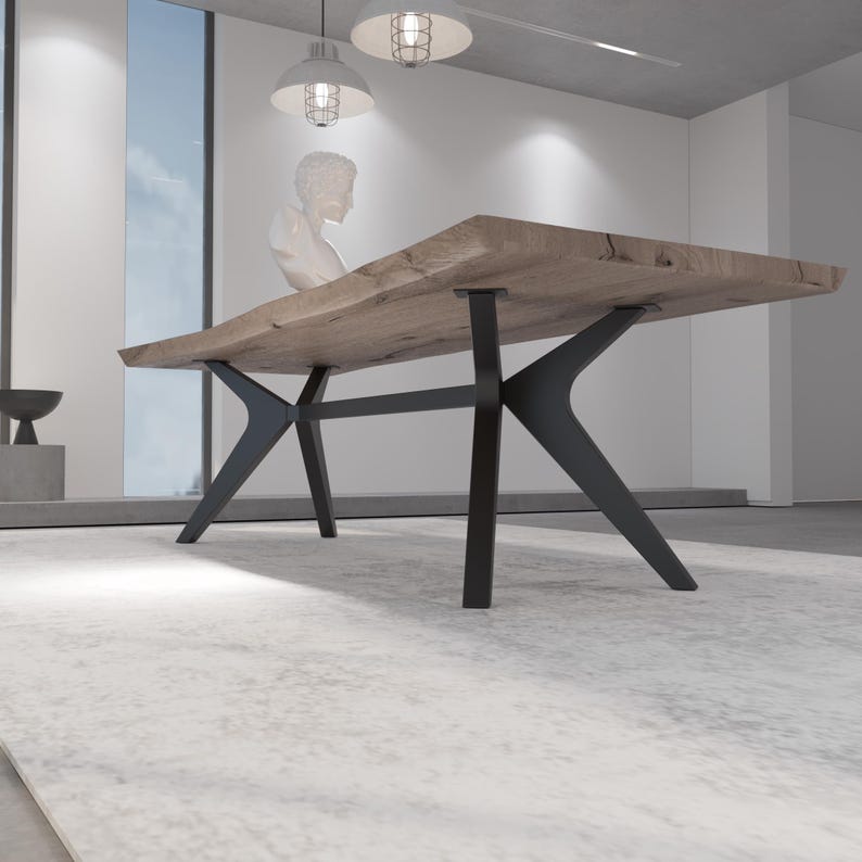 May include: A large, rectangular wooden dining table with a natural edge. The tabletop is supported by black, angular metal legs. The table is set on a light-colored rug in a modern, minimalist interior.