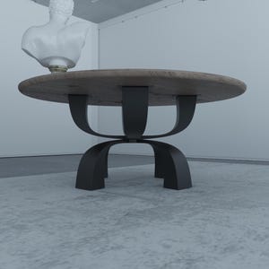 May include: A round wooden coffee table with a black metal base. The base has a unique design with three curved legs that connect in the middle.