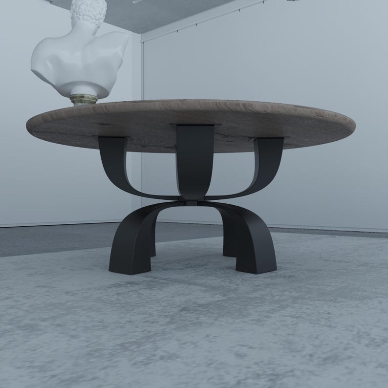 May include: A round wooden coffee table with a black metal base. The base has a unique design with three curved legs that connect in the middle.