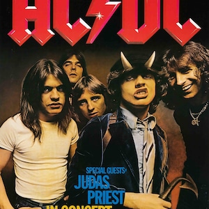 May include: Concert poster for AC/DC featuring the band members with the text "JUDAS PRIEST IN CONCERT". The AC/DC logo is in red with a lightning bolt. The poster includes concert dates and locations.