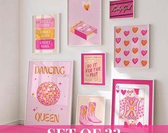 May include: A collection of framed art prints in shades of pink, featuring various designs. Prints include the text "Lucky Girl", a matchbox, hearts, a disco ball, cowboy boots, and a playing card. The phrase "Set of 22" is at the bottom.