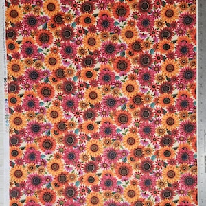 May include: A fabric with a repeating pattern of sunflowers in shades of orange, red, and yellow. The sunflowers are of varying sizes and are set against a cream-colored background. The fabric is printed with the text "elizabeth's studio. PATT 43001".