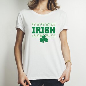 May include: White t-shirt with a green shamrock and the text "IRISH" repeated three times.