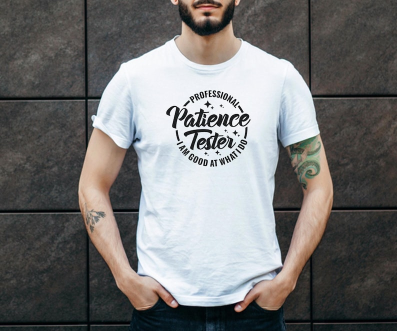 May include: White t-shirt with a black circle graphic that says "Professional Patience Tester - I am good at what I do".