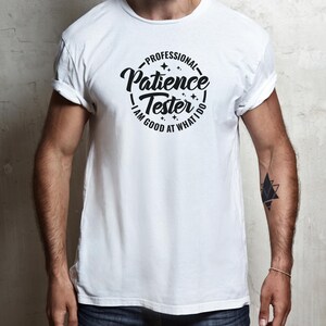 May include: White t-shirt with a black circle graphic that says "Professional Patience Tester I am good at what I do".
