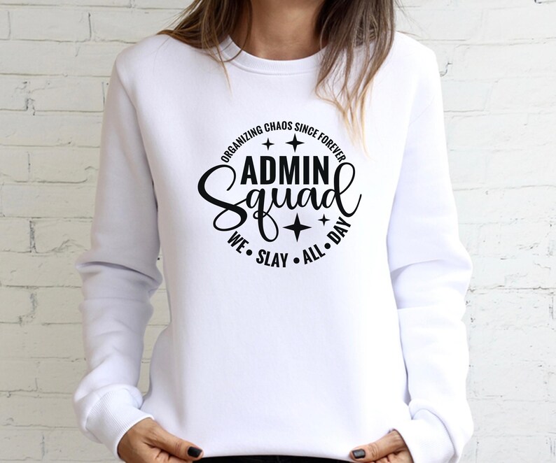 Może przedstawiać: Biała bluza z czarnym napisem "Organizing Chaos Since Forever Admin Squad We Slay All Day" z gwiazdami wok&oacute;ł tekstu.
