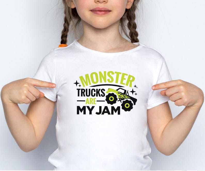 May include: White t-shirt with a green graphic that says "Monster Trucks Are My Jam" and a black and yellow monster truck illustration.