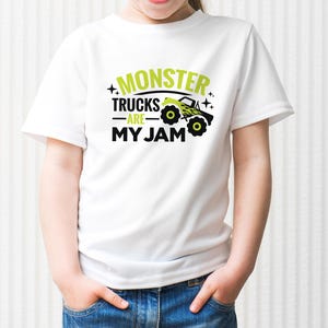 May include: White t-shirt with a green and black graphic that says "Monster Trucks Are My Jam".