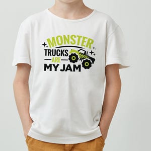 May include: White t-shirt with a green and black graphic that says "Monster Trucks Are My Jam". The graphic includes a cartoon monster truck.