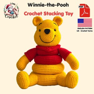 May include: A crocheted Winnie-the-Pooh stacking toy in yellow and red. The toy has a smiling face, a red shirt, and a stackable base. The image includes text that says "Winnie-the-Pooh Crochet Stacking Toy" and "English Pattern US - Crochet Terms".