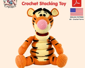May include: A crochet stacking toy shaped like Tigger, featuring orange and cream yarn with black stripes, a pink nose, and black eyes. The text reads Tigger Crochet Stacking Toy, PDF, and English Pattern US - Crochet Terms with a US flag icon.