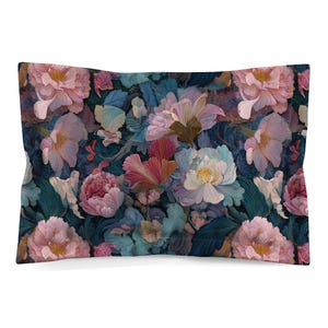 May include: A rectangular pillow sham featuring a dense, repeating floral pattern. The design showcases large, layered peony-like blossoms in shades of soft pink, cream, and deep magenta, set against a dark, moody background of teal and navy foliage.