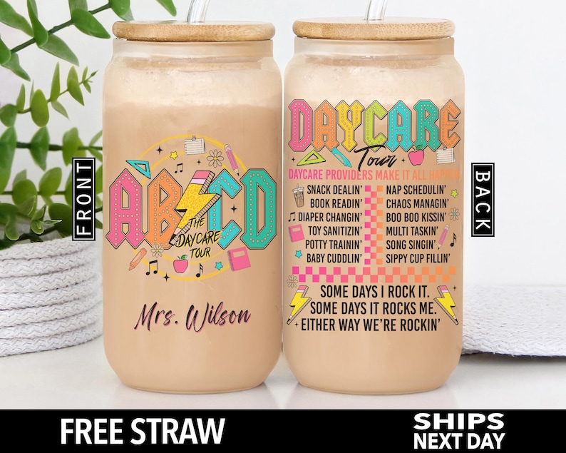 May include: Two personalized, reusable, clear plastic tumblers with bamboo lids and straws. The tumblers are decorated with a colorful ABC design and the text "The Daycare Tour" on one side and the text "Daycare Tour" with a list of daycare provider duties on the other side. The text "Mrs. Wilson" is printed on the bottom of one tumbler.