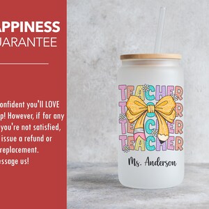 May include: A frosted glass tumbler with a bamboo lid and a straw. The tumbler has a colorful graphic of a pencil and a bow with the word "TEACHER" repeated. The text "Ms. Anderson" is printed below the graphic.
