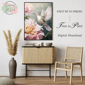 May include: A digital download paint by numbers image featuring a hummingbird in flight over a pink flower. The text "Paint by Numbers | Time to Paint | Digital Download" is displayed on a white background.
