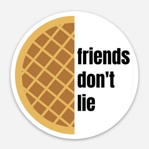 May include: A white circle sticker with a brown waffle graphic on the left side and the text "friends don't lie" in black on the right side.