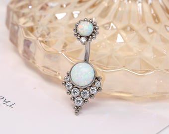 May include: A silver belly button ring with two white opal stones and a cluster of clear rhinestones.
