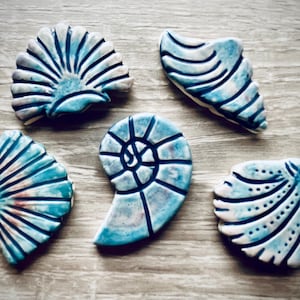 Handmade set of 5 shell design mosaic tiles. Incised and hand painted surface decoration make these unique pieces to use in your own work.