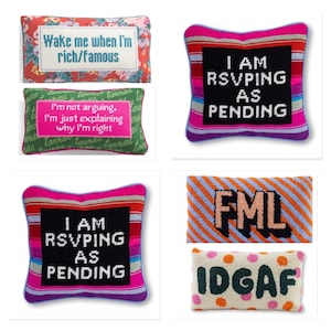 May include: A collection of six rectangular and square needlepoint cushions featuring various text designs including Wake me when I'm rich/famous, I'm not arguing, I'm just explaining why I'm right, I AM RSVPING AS PENDING, FML, and IDGAF in colourful patterns.