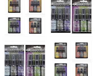 May include: A set of three small bottles of Distress Mica Stain in various colors. The bottles are labeled with the product name and have a black spray nozzle. The bottles are packaged in a clear plastic box with a white label.