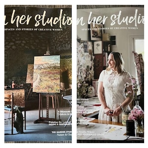 May include: A white ceramic mug with a black handle and the text "But First, Coffee" in a bold, black font. The mug is set against a blurred background, suggesting a cozy setting.