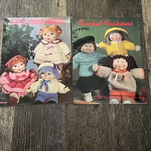 May include: Two crochet pattern books featuring dolls. The first book is titled "Little Sweethearts" and features four dolls in various outfits. The second book is titled "Crochet Fashions" and features three dolls in different outfits.