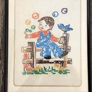 Vintage Completed embroidered cross stitch. In metal frame. 8”x10”
