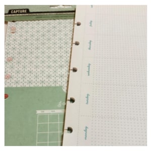 May include: A planner with a weekly layout, featuring a white background with light green dotted lines and text. The left side includes decorative paper with a snowflake pattern and a calendar. The word "CAPTURE" is visible at the top.