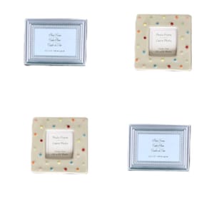 May include: Four small picture frames, two with a silver frame and two with a beige frame with colorful polka dots. The frames are all the same size and have a small opening for a 1.5 x 2 inch photo. The frames say "Photo Frame, Cadre Photo, Holds One 1.5 x 2 Photo".