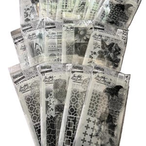 May include: A collection of 14 clear plastic packages containing black and white stamps and stencils. The packages are labeled "Stamps Anonymous Collection" and feature various designs, including geometric patterns, flowers, butterflies, and text.