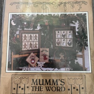 May include: A white ceramic mug with a black handle and the text "But First, Coffee" in a black, handwritten-style font. The mug is on a white surface.