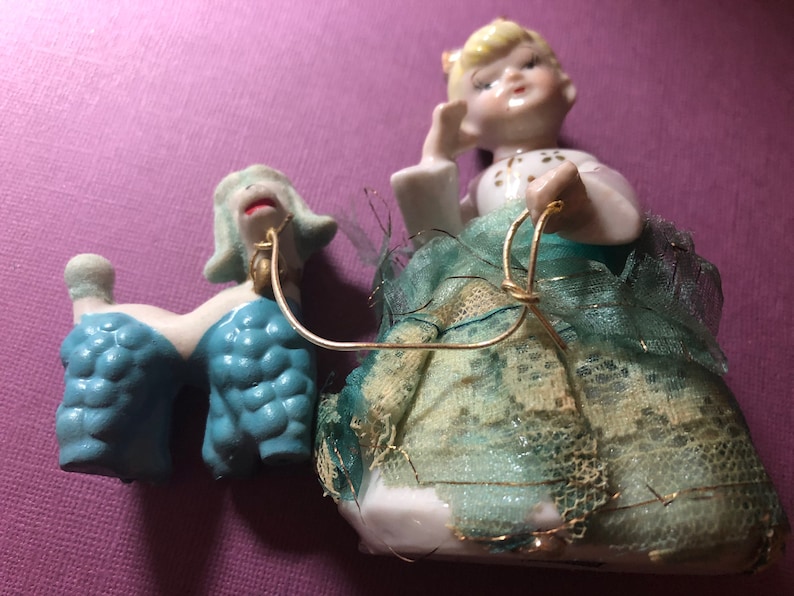 She is wearing a blue lace dress Vintage Antique Girl figurine with blue poodle 50s era.