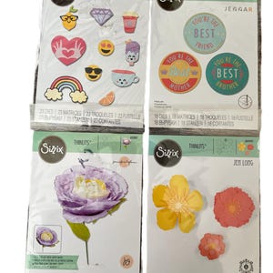 May include: Four Sizzix Thinlits die packages. The packs contain designs such as emojis, a rainbow, flowers, and phrases like "Best Friend" and "Best Mother". The packages are sealed in clear plastic.