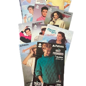 May include: A collection of vintage Patons knitting pattern booklets. The covers feature images of women wearing knitted sweaters and other garments. The booklets have titles like "Knit Fashions" and "Follow the Sun."