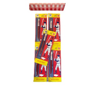 May include: A set of six red and white baseball pen packages. Each package features a cartoon baseball player holding a bat and a ball pen. The text on the package reads "Little League Ball Pen".