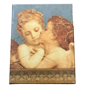 May include: A rectangular canvas print featuring a classical artwork of two cherubic figures in a tender embrace. The artwork has a distressed, aged appearance with a light blue background and a decorative border.