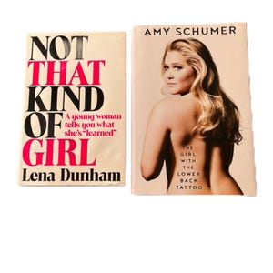 May include: Two paperback books, one titled "Not That Kind of Girl" by Lena Dunham and the other titled "The Girl with the Lower Back Tattoo" by Amy Schumer.