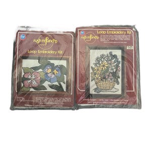 May include: Two vintage "rush n' funcho" Loop Embroidery Kits. One kit features pansies, the other a spring bouquet in a basket. Both kits are in their original packaging, with the text "Loop Embroidery Kit" visible.