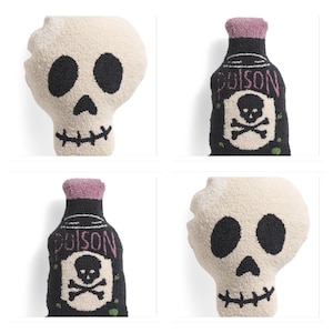 May include: Two plush Halloween pillows, one shaped like a skull and the other shaped like a poison bottle. The skull pillow is white with black eyes and a black mouth. The poison bottle pillow is black with a purple top and the word "Poison" written on it in white letters. There is a skull and crossbones design on the bottle.
