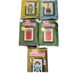 May include: A selection of vintage Jiffy cstitchery kits. The kits feature cross-stitch designs of a tram, a sailing boat, jars of fruit, and a girl with flowers. Each kit includes a frame offer.