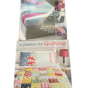 May include: Two quilting books are stacked on top of each other. The top book is titled "Crazy Quilting in a Weekend" and features a colorful quilt on the cover. The bottom book is titled "a passion for Quilting" and shows a patchwork quilt.
