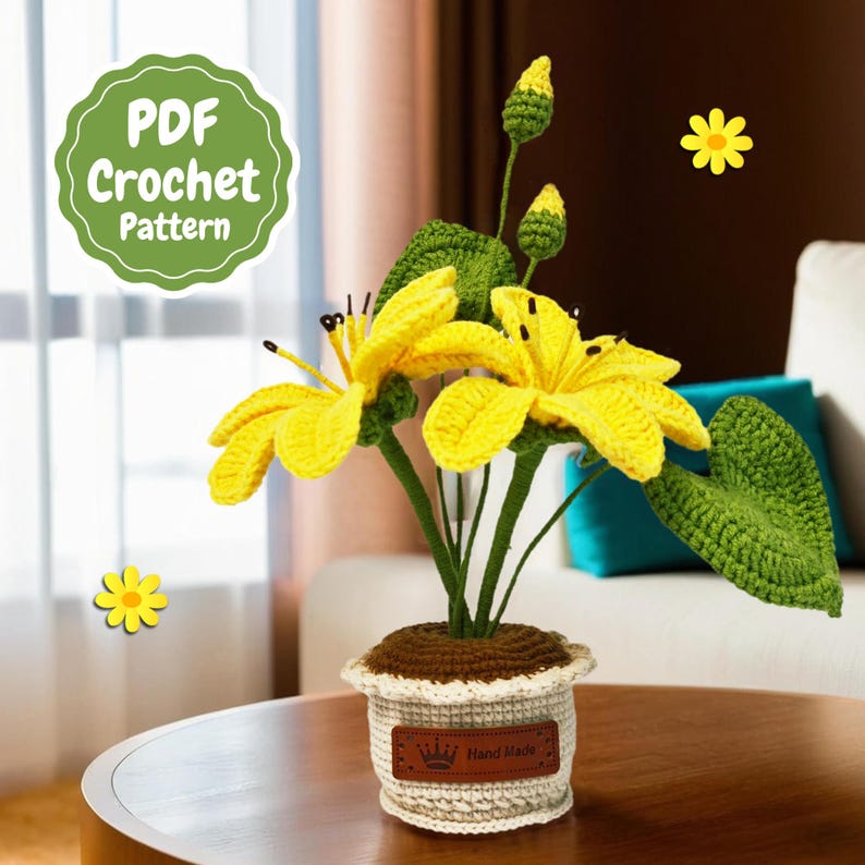 May include: A crocheted yellow flower arrangement in a white pot with a brown base. The pot has a brown label that says "Hand Made".