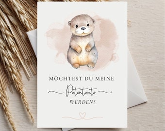 May include: A card with a watercolor illustration of an otter on a pink background. The text on the card reads "Möchtest du meine Patenante werden?" which translates to "Would you like to be my godmother?"